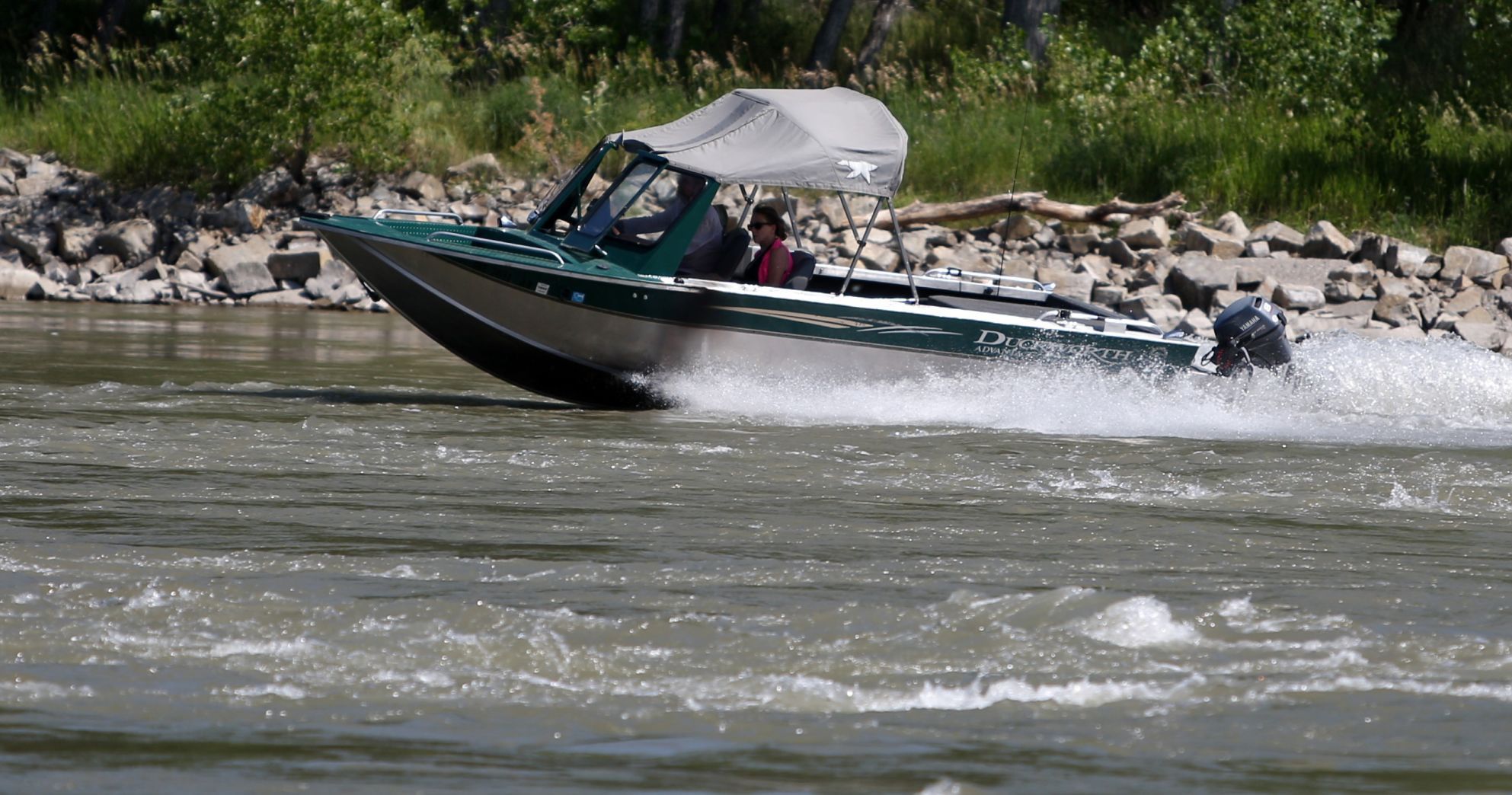 A boat heads down the Yellowstone River